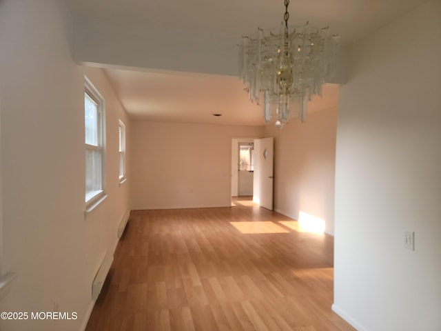 799 Hudson Pkwy, Whiting, NJ 08759 - empty room with a chandelier, light wood-style flooring, baseboards, and a baseboard heating unit
