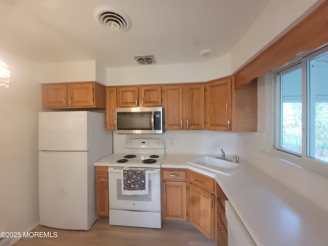 799 Hudson Pkwy, Whiting, NJ 08759 - kitchen with white appliances, a sink, light countertops, and light wood-style floors