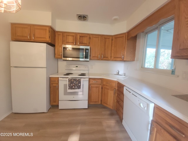 799 Hudson Pkwy, Whiting, NJ 08759 - kitchen featuring white appliances, light wood-type flooring, light countertops, and brown cabinetry