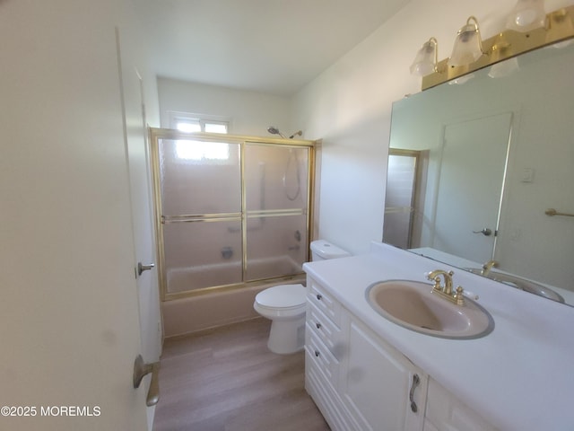 799 Hudson Pkwy, Whiting, NJ 08759 - bathroom with toilet, vanity, wood finished floors, and bath / shower combo with glass door