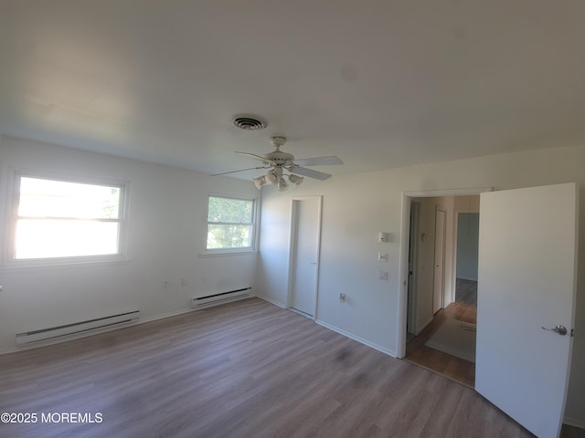 799 Hudson Pkwy, Whiting, NJ 08759 - unfurnished bedroom featuring a baseboard heating unit, a baseboard radiator, wood finished floors, a closet, and ceiling fan