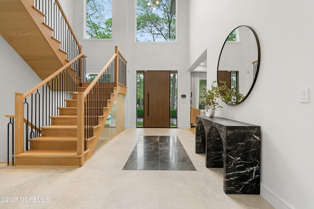 428 Wells Ave, Oakhurst, NJ 07755 - foyer with marble tiled floors, a towering ceiling, stairs, and baseboards