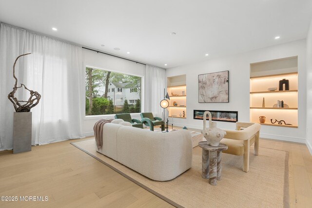 428 Wells Ave, Oakhurst, NJ 07755 - living area featuring light wood-style flooring, recessed lighting, and a glass covered fireplace