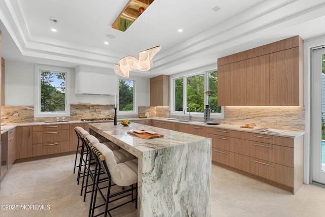 428 Wells Ave, Oakhurst, NJ 07755 - kitchen with modern cabinets, a breakfast bar, backsplash, a raised ceiling, and recessed lighting