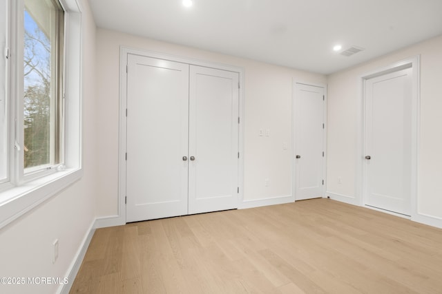 428 Wells Ave, Oakhurst, NJ 07755 - unfurnished bedroom featuring light wood-style flooring, multiple windows, baseboards, and recessed lighting