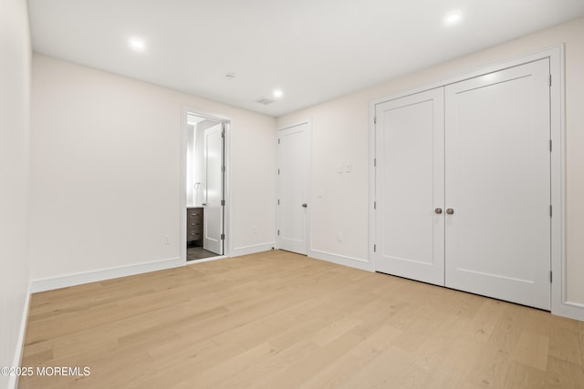 428 Wells Ave, Oakhurst, NJ 07755 - unfurnished bedroom with two closets, light wood finished floors, recessed lighting, baseboards, and connected bathroom