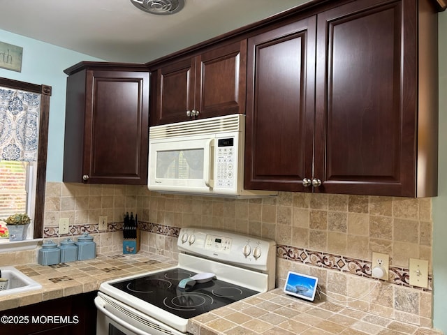 75 Hudson Pkwy Unit C, Whiting, NJ 08759 - kitchen with white appliances, dark brown cabinets, tile counters, and backsplash