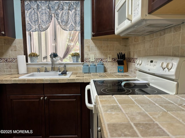 75 Hudson Pkwy Unit C, Whiting, NJ 08759 - kitchen with white appliances, dark brown cabinets, and tile countertops