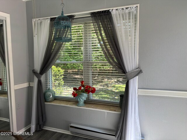 75 Hudson Pkwy Unit C, Whiting, NJ 08759 - detailed view of a baseboard radiator, baseboards, and wood finished floors