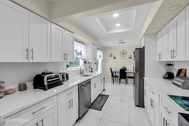 404B Newport Way, Monroe, NJ 08831 - kitchen featuring stainless steel appliances, a tray ceiling, light marble finish floors, white cabinetry, and recessed lighting