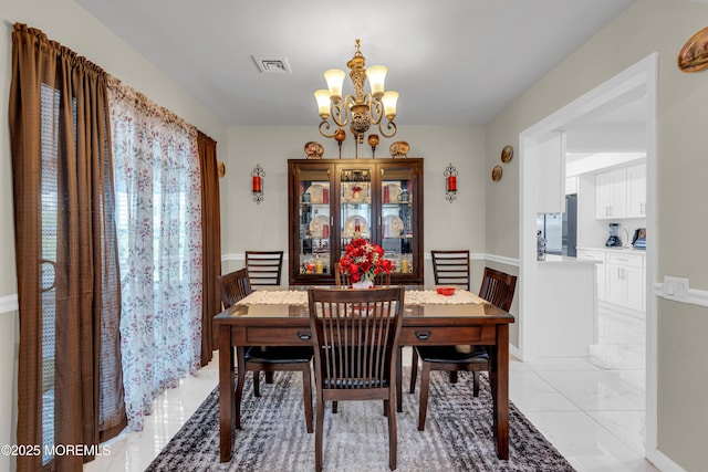404B Newport Way, Monroe, NJ 08831 - dining space featuring a chandelier, light marble finish flooring, and a wainscoted wall