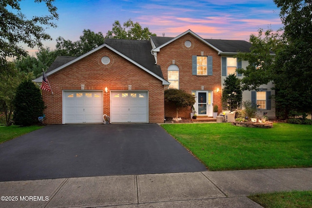 18 Mount Ranier Dr, Howell, NJ 07731 - view of front of home with asphalt driveway, an attached garage, a front lawn, and brick siding