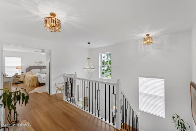 18 Mount Ranier Dr, Howell, NJ 07731 - hallway with a chandelier, an upstairs landing, wood finished floors, and baseboards