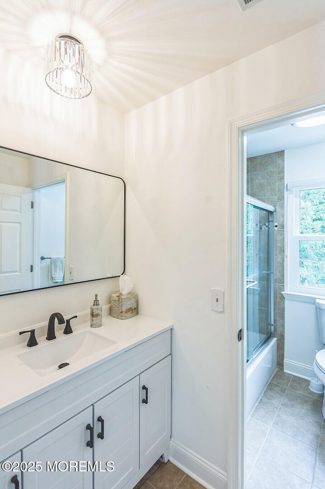 18 Mount Ranier Dr, Howell, NJ 07731 - full bath featuring toilet, vanity, enclosed tub / shower combo, tile patterned floors, and baseboards