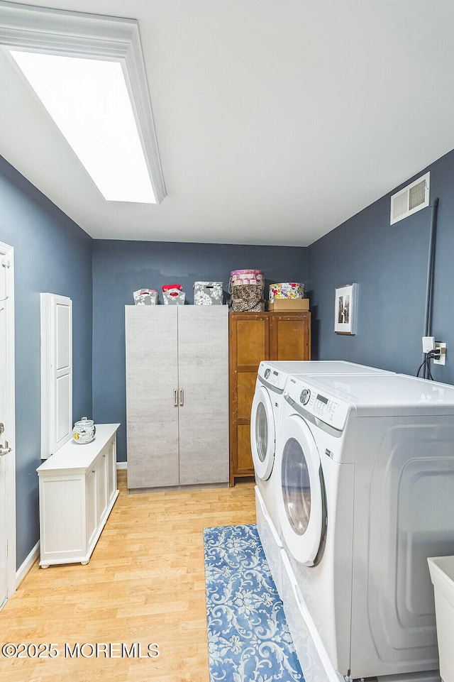 18 Mount Ranier Dr, Howell, NJ 07731 - laundry room featuring cabinet space, washing machine and dryer, and light wood finished floors