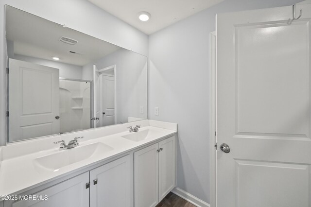 1980 Breakers Dr, Barnegat, NJ 08005 - full bath with double vanity, a shower, wood finished floors, baseboards, and recessed lighting