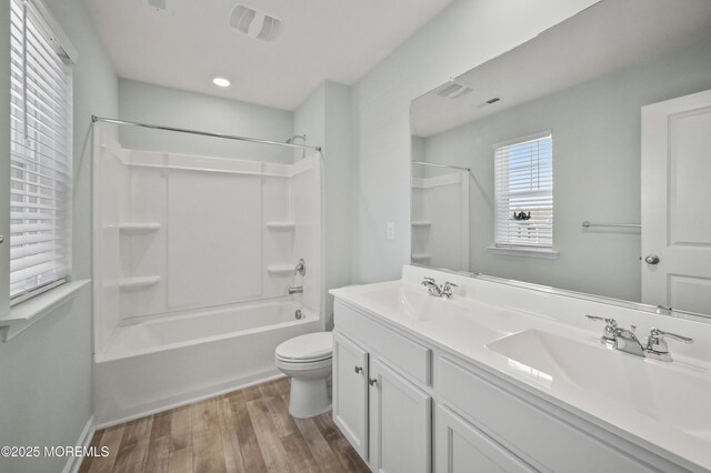 1980 Breakers Dr, Barnegat, NJ 08005 - bathroom with wood finished floors, double vanity, toilet, bathtub / shower combination, and baseboards
