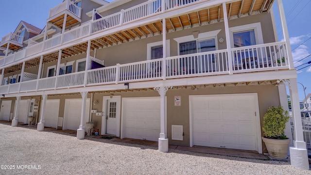 33 Sumner Ave Unit 1A, Seaside Heights, NJ 08751 - rear view of property with stucco siding and a garage