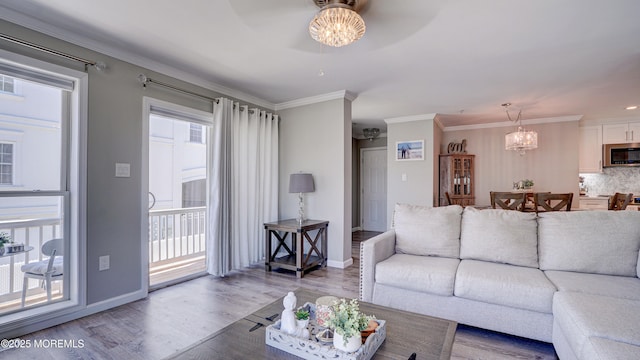 33 Sumner Ave Unit 1A, Seaside Heights, NJ 08751 - living area with wood finished floors, a chandelier, a ceiling fan, crown molding, and baseboards