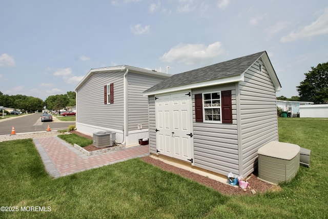 610 Jerome Pl, Freehold, NJ 07728 - rear view of house featuring a yard, a shed, and roof with shingles
