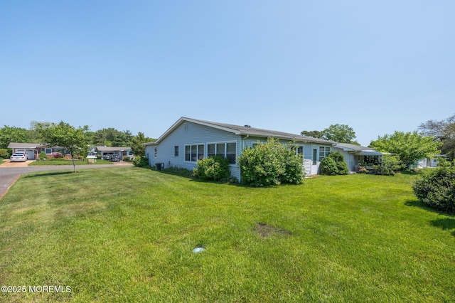 19 Clay Cir, Brick, NJ 08724 - view of side of home featuring a yard and cooling unit