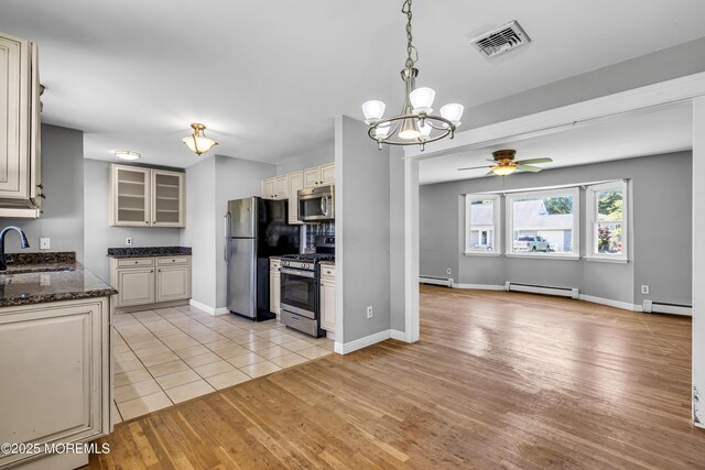55 S Ave, Bayville, NJ 08721 - kitchen featuring appliances with stainless steel finishes, a baseboard heating unit, a sink, a ceiling fan, and light wood finished floors