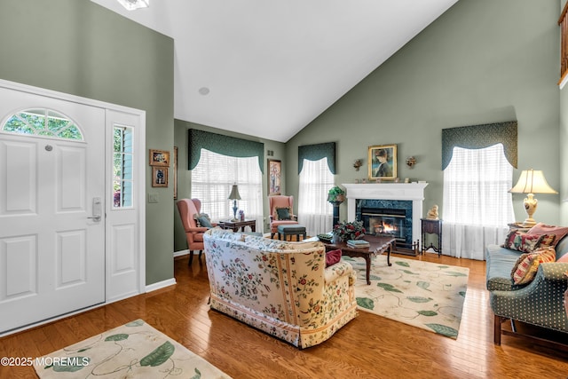 123 Skyline Dr, Lakewood, NJ 08701 - living area featuring high vaulted ceiling, healthy amount of natural light, a fireplace, wood finished floors, and baseboards