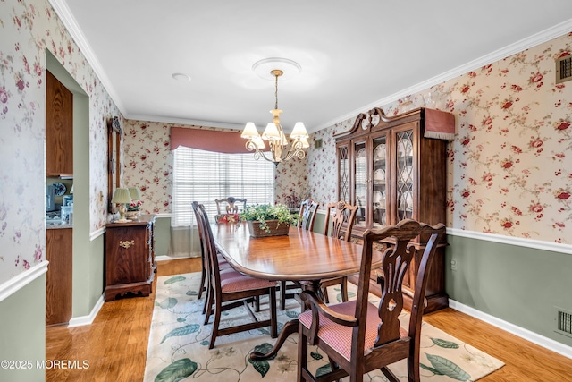 123 Skyline Dr, Lakewood, NJ 08701 - dining area with light wood-style floors, a chandelier, wallpapered walls, and crown molding