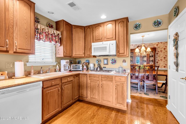 123 Skyline Dr, Lakewood, NJ 08701 - kitchen with white appliances, light countertops, light wood-style floors, wallpapered walls, and a sink