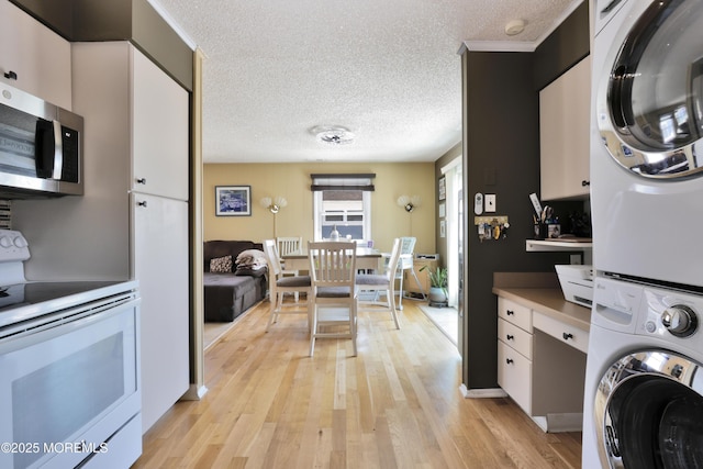 67 Flax Isle Dr, Little Egg Harbor, NJ 08087 - laundry room featuring stacked washer / dryer, a textured ceiling, and light wood-style floors