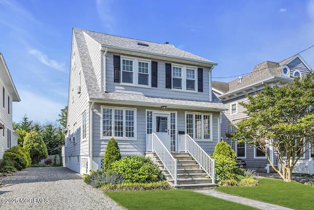129 Bridge Ave, Bay Head, NJ 08742 - view of front of home featuring gravel driveway, a shingled roof, and a front yard