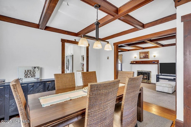129 Bridge Ave, Bay Head, NJ 08742 - dining space featuring coffered ceiling, beam ceiling, wood finished floors, and a warm lit fireplace