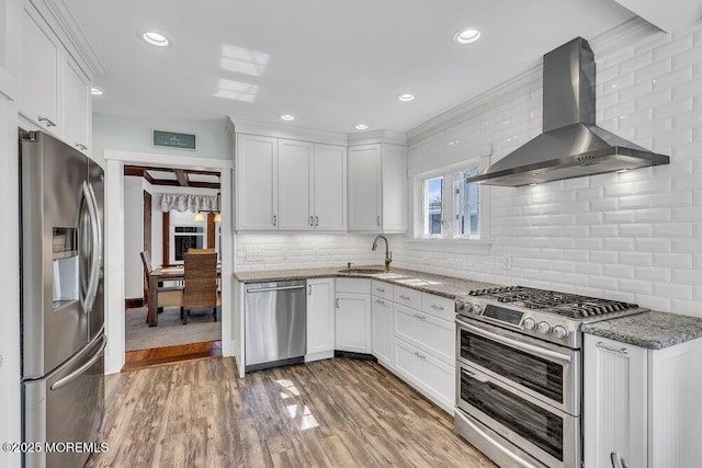 129 Bridge Ave, Bay Head, NJ 08742 - kitchen with appliances with stainless steel finishes, wall chimney exhaust hood, white cabinets, decorative backsplash, and stone countertops