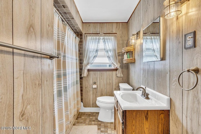 129 Bridge Ave, Bay Head, NJ 08742 - full bathroom with toilet, vanity, wooden walls, and a shower with shower curtain