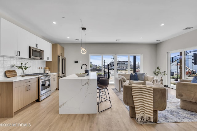401 Boulevard 201, Seaside Heights, NJ 08751 - kitchen with high quality appliances, light wood-style floors, open floor plan, a kitchen bar, and decorative backsplash