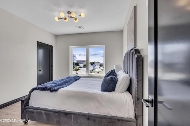 401 Boulevard 201, Seaside Heights, NJ 08751 - bedroom featuring light wood-style flooring, freestanding refrigerator, baseboards, and a chandelier