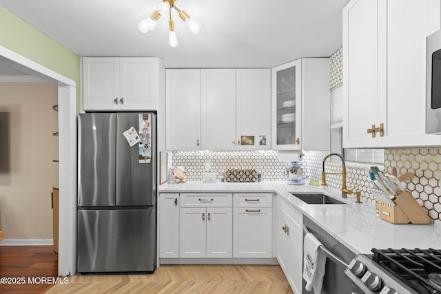 20 Lindsey Cir Unit 20, Old Bridge, NJ 08857 - kitchen featuring stainless steel appliances, a sink, white cabinetry, and backsplash