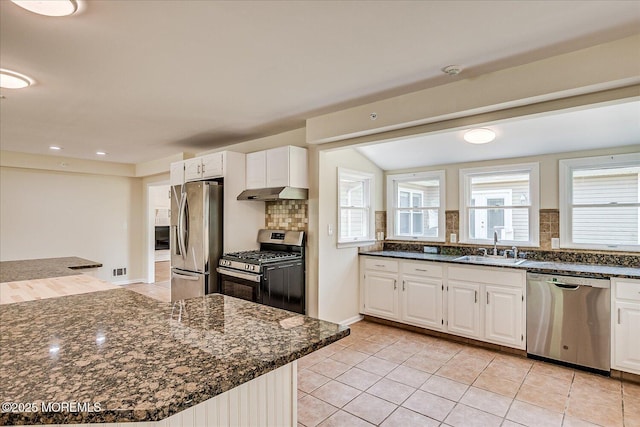 44 Oak Ter, Howell, NJ 07731 - kitchen featuring appliances with stainless steel finishes, under cabinet range hood, backsplash, white cabinets, and dark stone countertops