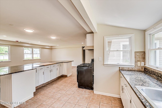 44 Oak Ter, Howell, NJ 07731 - kitchen with gas range, light tile patterned flooring, a sink, white cabinetry, and vaulted ceiling