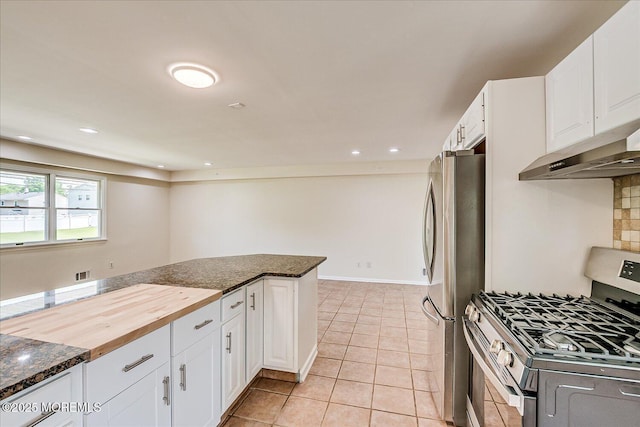 44 Oak Ter, Howell, NJ 07731 - kitchen with appliances with stainless steel finishes, under cabinet range hood, white cabinetry, light tile patterned floors, and dark stone countertops