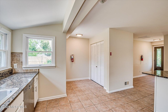 44 Oak Ter, Howell, NJ 07731 - kitchen with dishwasher, dark stone countertops, light tile patterned flooring, white cabinets, and lofted ceiling