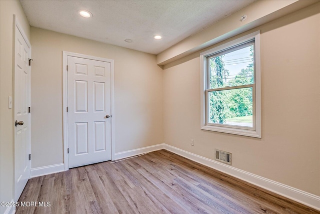 44 Oak Ter, Howell, NJ 07731 - unfurnished room with wood finished floors, recessed lighting, baseboards, and a textured ceiling