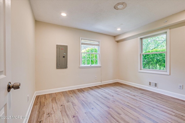 44 Oak Ter, Howell, NJ 07731 - unfurnished room with electric panel, light wood-style floors, baseboards, recessed lighting, and a textured ceiling