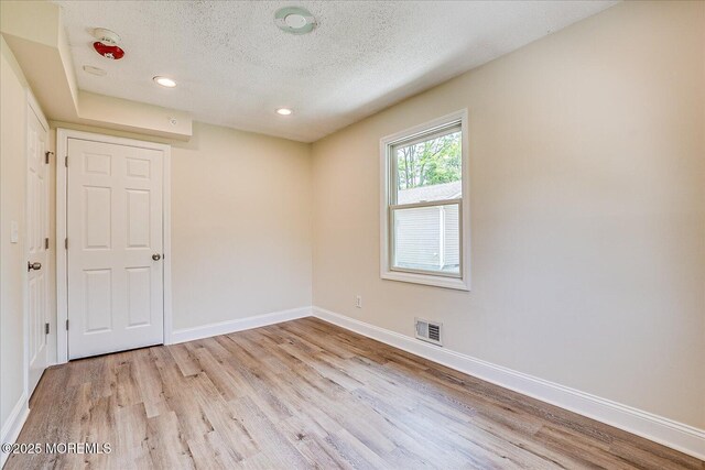 44 Oak Ter, Howell, NJ 07731 - spare room with light wood-style floors, a textured ceiling, baseboards, and recessed lighting