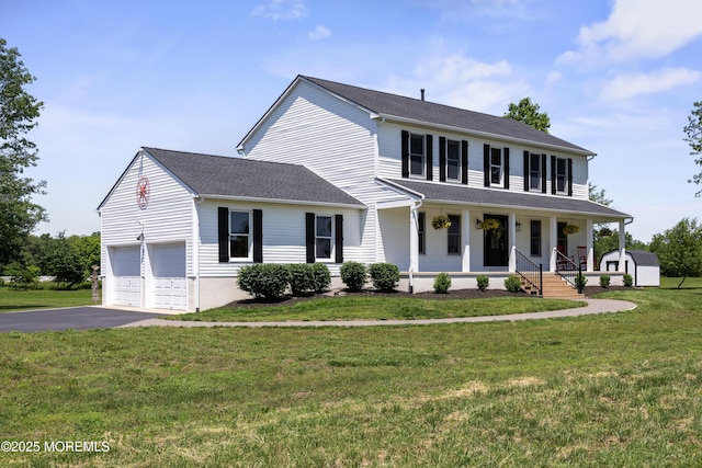 69 Eayrestown Rd, Medford, NJ 08055 - view of front of property featuring covered porch, asphalt driveway, a garage, and a front lawn
