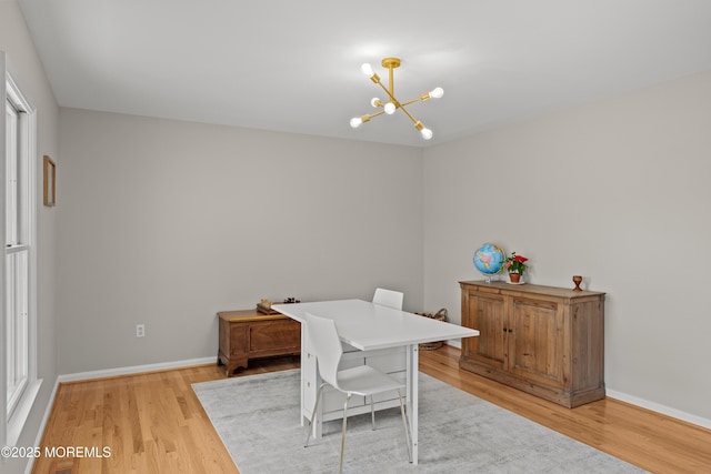 69 Eayrestown Rd, Medford, NJ 08055 - dining room with a chandelier, light wood finished floors, and baseboards