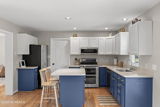 69 Eayrestown Rd, Medford, NJ 08055 - kitchen featuring blue cabinets, appliances with stainless steel finishes, a sink, light wood finished floors, and recessed lighting