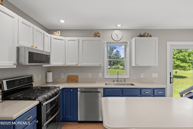 69 Eayrestown Rd, Medford, NJ 08055 - kitchen featuring stainless steel appliances, a sink, blue cabinets, white cabinets, and recessed lighting