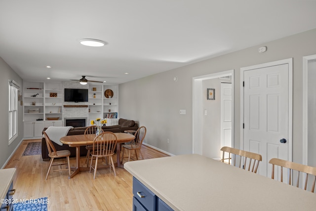 69 Eayrestown Rd, Medford, NJ 08055 - dining room featuring a ceiling fan, a fireplace, light wood-style flooring, baseboards, and recessed lighting