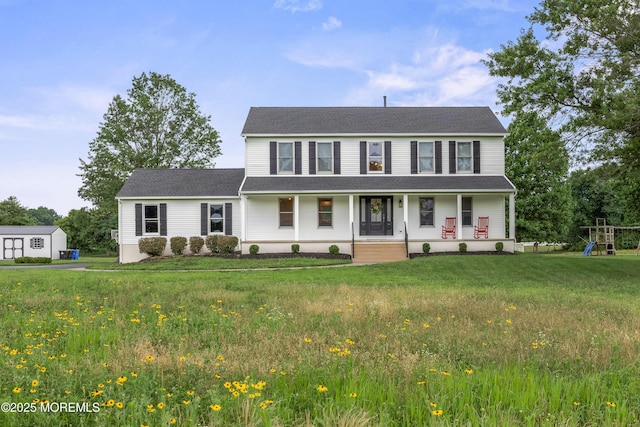 69 Eayrestown Rd, Medford, NJ 08055 - view of front of house featuring covered porch, a playground, and a front yard
